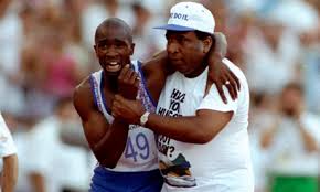 Iconic photo of father helping his son over the finish line.  But I always wondered whether the runner had wanted to limp over himself, or whether the father's actions disqualified him from being recorded as a finisher.